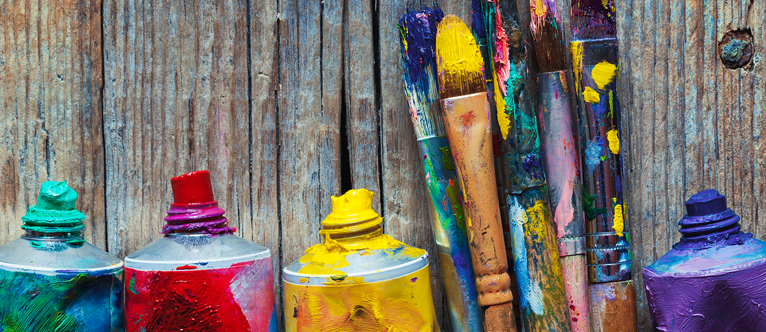 Tubes of oil paint and artist paint brushes closeup